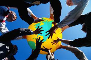 Group holding up a globe